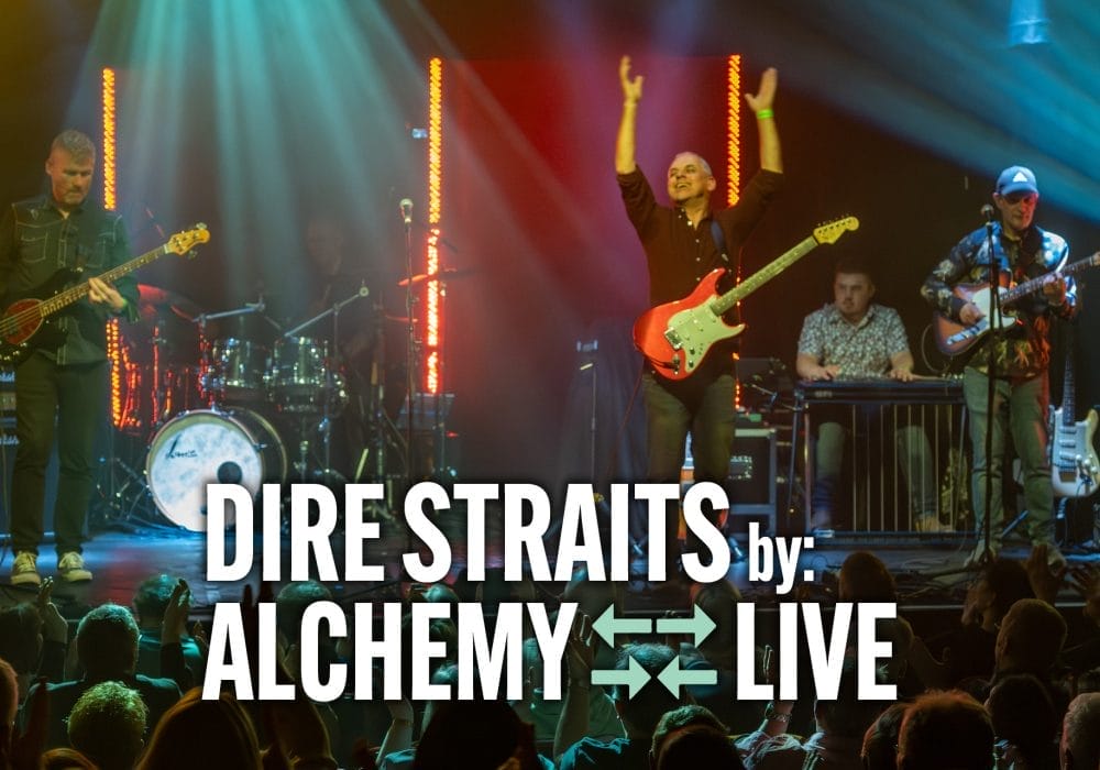 Alchemy performing "Dire Straits" live, featuring musicians energetically playing instruments under colourful stage lights.