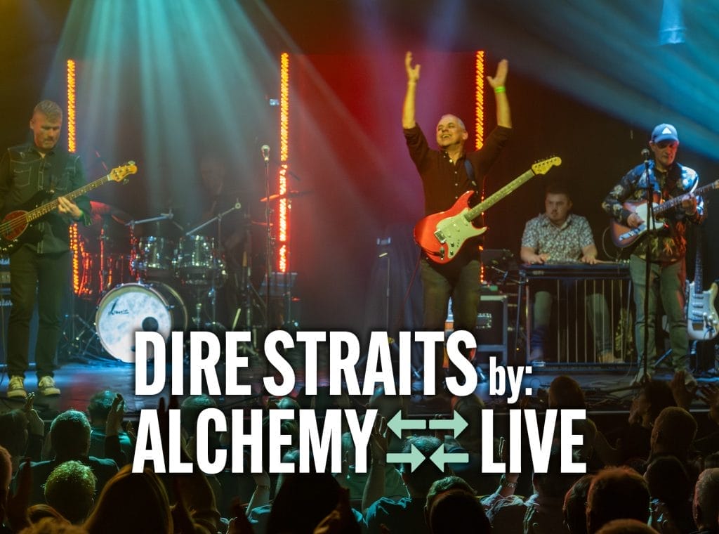 Alchemy performing "Dire Straits" live, featuring musicians energetically playing instruments under colourful stage lights.