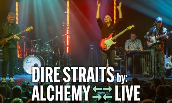 Alchemy performing "Dire Straits" live, featuring musicians energetically playing instruments under colourful stage lights.