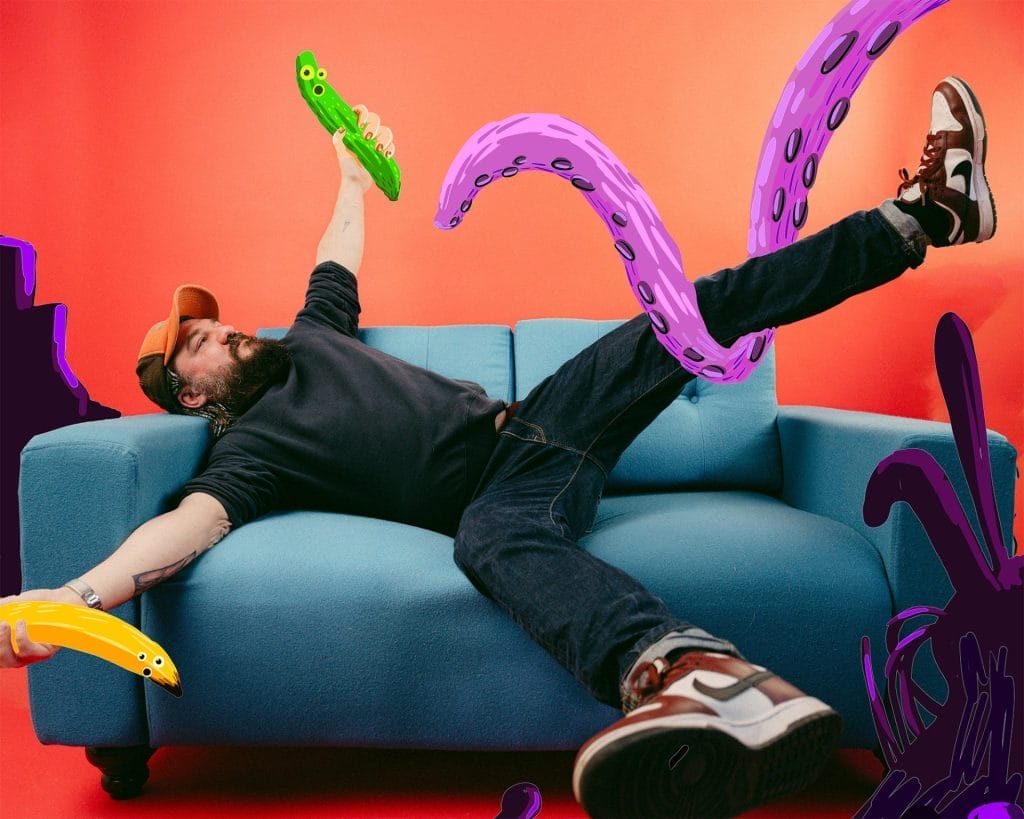 A person lying on a light blue sofa against a vibrant orange-red background, appearing to be grabbed by large purple tentacles with suction cups. They're holding a green pickle-shaped object and wearing dark clothing with trainers. Yellow and purple tentacle-like shapes frame the scene, creating a surreal, playful composition that blends reality with fantastical elements.
