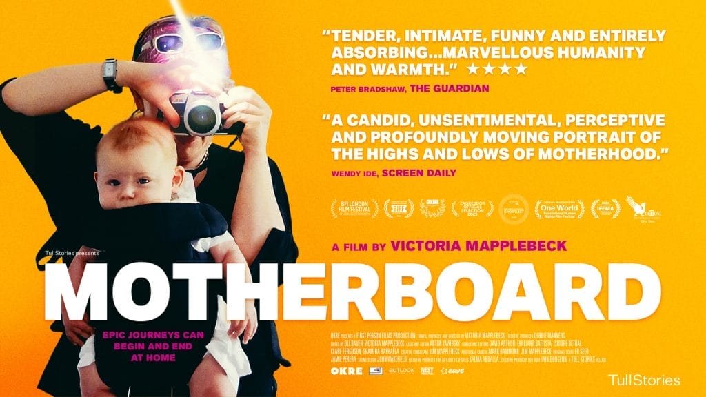 Film poster for "Motherboard," featuring a person with sunglasses and a camera, taking a picture of a baby held in a carrier; yellow background with quotes, film festival logos, and film credits.