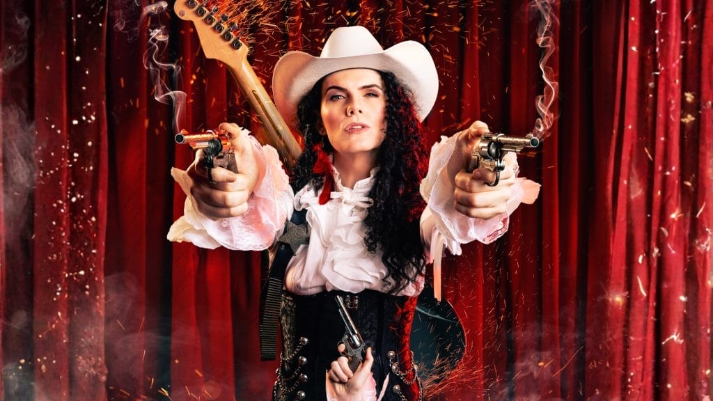 A strong and confident female wearing a cowboy hat and firing a pistol in each hand