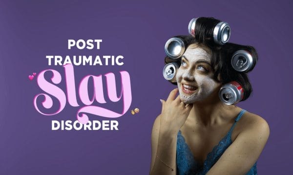 A woman with a face mask and Coke cans in her hair poses playfully against a purple background with the words 'Post Traumatic Slay Disorder.'