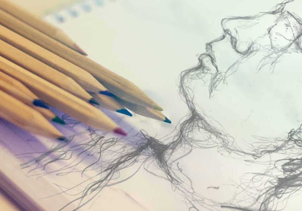 A drawing of a man's face created with various coloured pencils on textured paper.