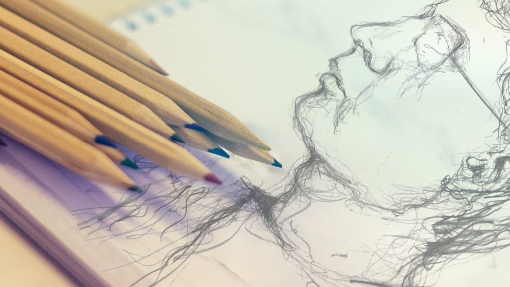 A drawing of a man's face created with various coloured pencils on textured paper.